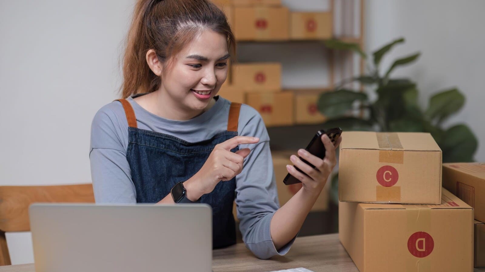 Young founder packing ecommerce orders from a home office