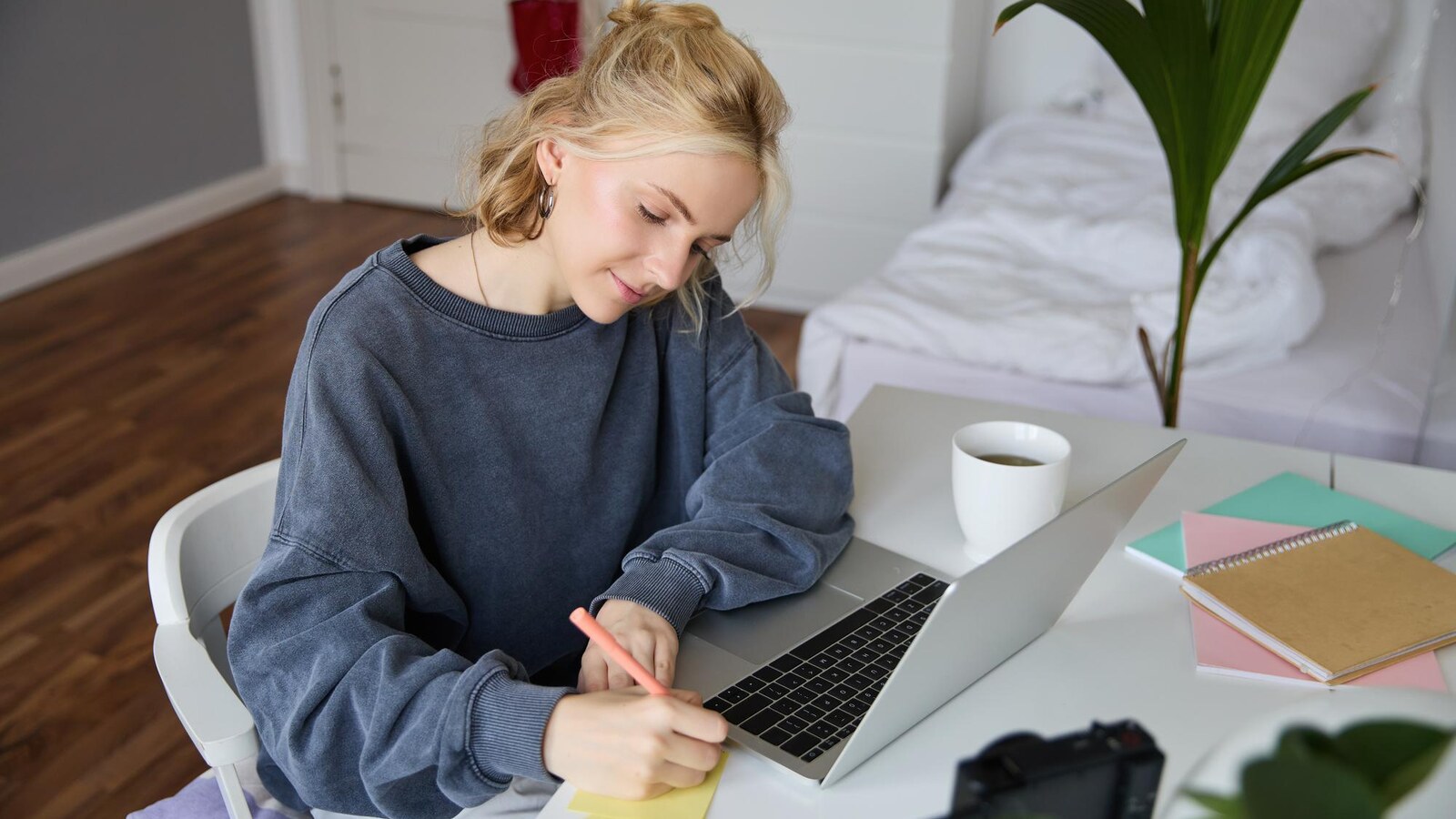 Student side income planning with notebook and freelance task list