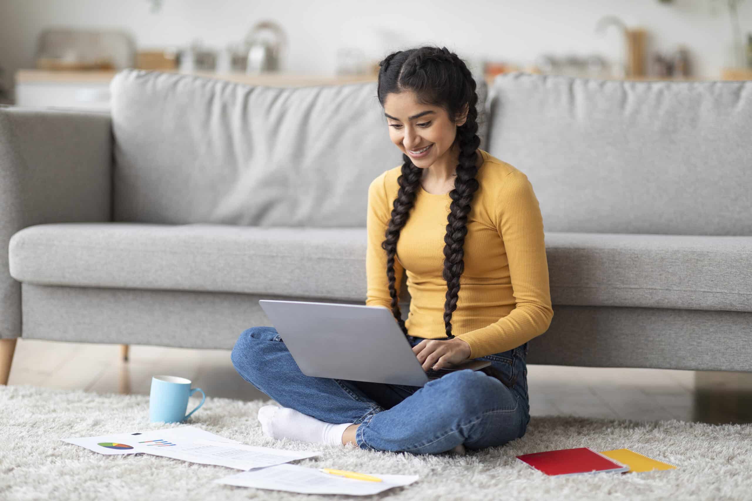 Freelance digital marketer planning a client campaign with notes and laptop